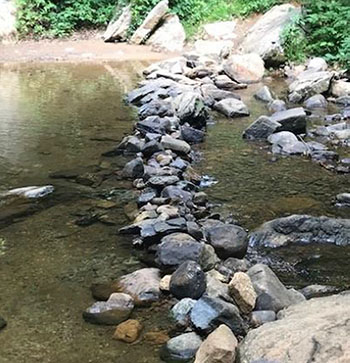 Rocks moved to create an illegal fishing hole.